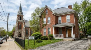 What is a Rectory in the Catholic Church? The Priest's Home Explained 9 A traditional brick Catholic rectory building located next to a parish church